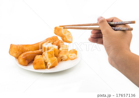 Chopsticks reaching for a piece of You Tiao 17657136