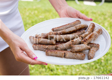 Woman serving sausage Woman serving sausage 17661142