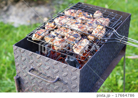 Meat on skewer frying on brazier Meat on skewer frying on brazier 17664786
