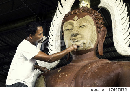 Man sculpting Buddha statue 17667636