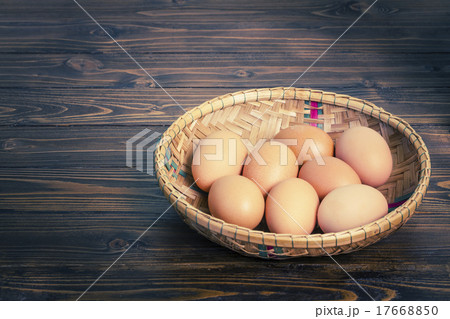 Eggs in bamboo basket on wooden table Eggs in bamboo basket on wooden table 17668850