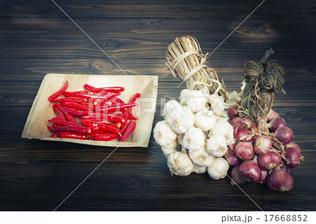Garlic and red onions and chili on wooden floor Garlic and red onions and chili on wooden floor 17668852