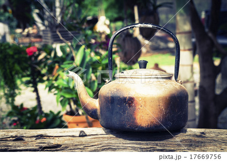 Old aluminium kettle on timber 17669756