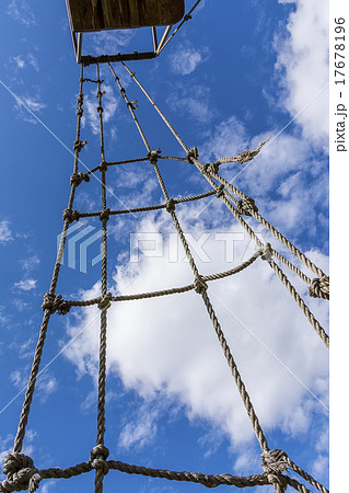 Old rope ladder against cloudy sky 17678196