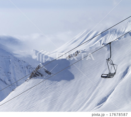 Chair lift and mountains in fog Chair lift and mountains in fog 17678587