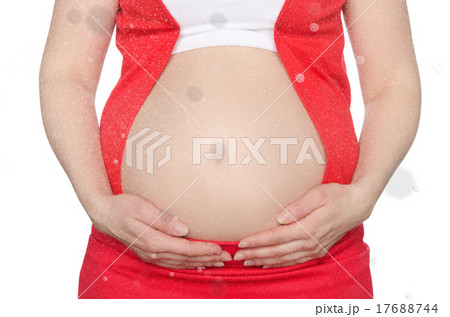 Pregnant woman supports stomach with falling snow Pregnant woman supports stomach with falling snow 17688744