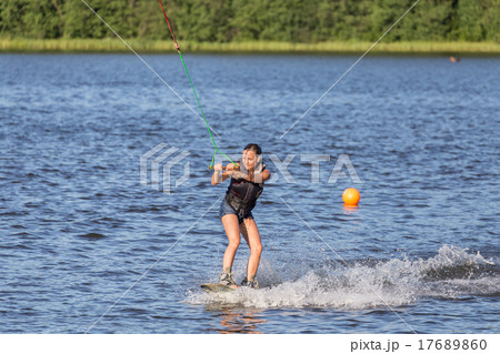 Woman riding wake board Woman riding wake board 17689860