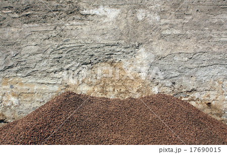 Brown gravel pile in front of the old wall. 17690015