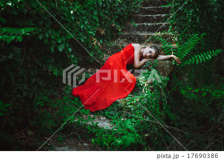 Beautiful woman in red dress lying on the steps Beautiful woman in red dress lying on the steps 17690386