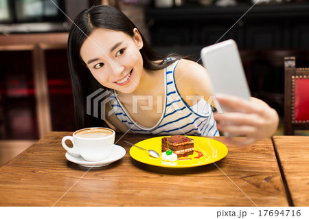girl in cafe shop texting on smartphone 17694716