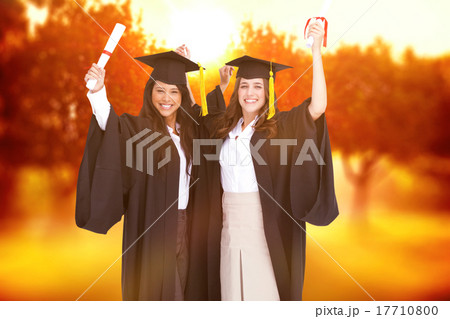 Composite image of two women celebrating their graduation Composite image of two women celebrating their graduation 17710800