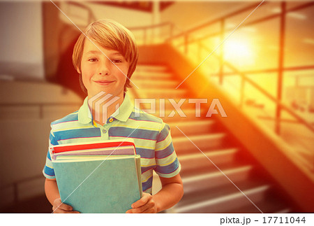 Composite image of cute pupil smiling at camera in library 17711044