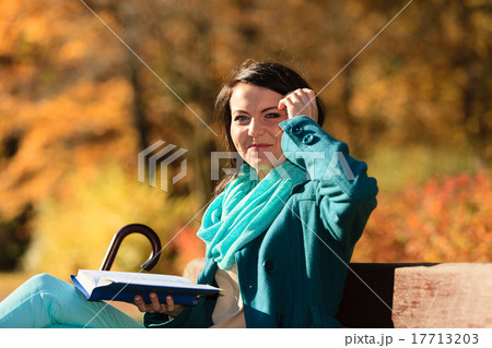 Girl relaxing in autumnal park reading book. Fall. Girl relaxing in autumnal park reading book. Fall. 17713203