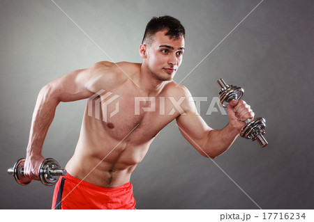 athletic man working with heavy dumbbells athletic man working with heavy dumbbells 17716234