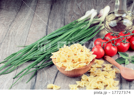 Raw farfalle pasta in bowl 17727374