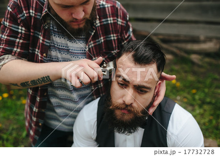 barber shaves a bearded man 17732728