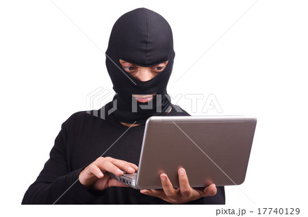 Hacker with computer wearing balaclava Hacker with computer wearing balaclava 17740129