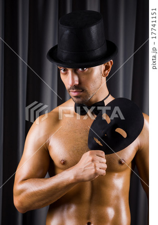 Muscular actor with mask against curtain 17741151
