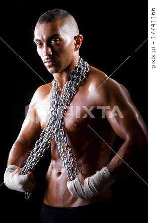 Muscular man with chain on black background Muscular man with chain on black background 17741166