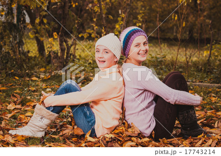 Sisters playing with leaves Sisters playing with leaves 17743214