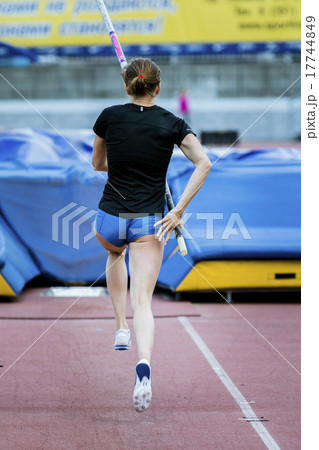 A female athlete competing in the pole vault 17744849