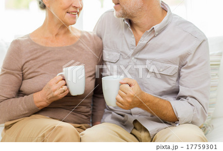 close up of happy senior couple with cups at home close up of happy senior couple with cups at home 17759301