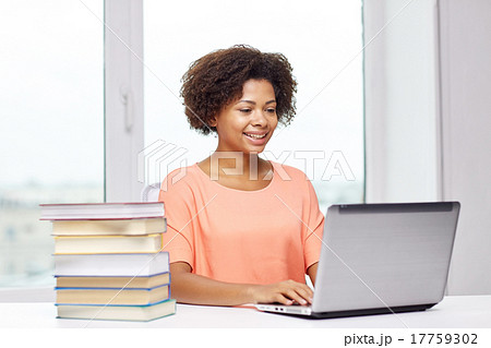 happy african american woman with laptop at home 17759302