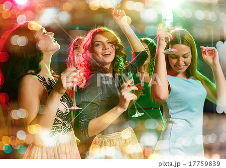 smiling friends with glasses of champagne in club smiling friends with glasses of champagne in club 17759839