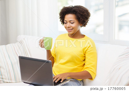 happy african american woman with laptop at home happy african american woman with laptop at home 17760005