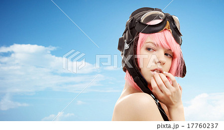 pink hair girl in aviator helmet over blue sky 17760237