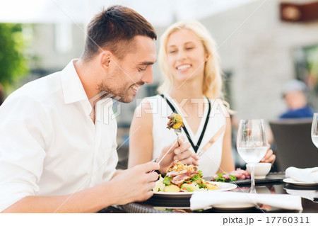 happy couple eating dinner at restaurant terrace happy couple eating dinner at restaurant terrace 17760311