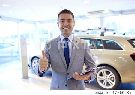 happy man at auto show or car salon happy man at auto show or car salon 17760535