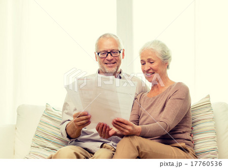 happy senior couple with papers at home happy senior couple with papers at home 17760536