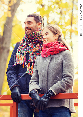 smiling couple hugging on bridge in autumn park 17760942