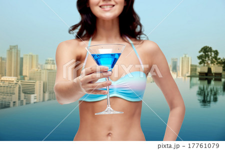 happy young woman in swimsuit drinking cocktail 17761079