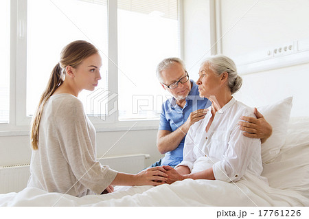 family visiting ill senior woman at hospital family visiting ill senior woman at hospital 17761226