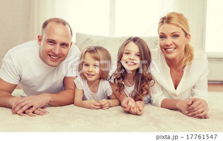 parents and two girls lying on floor at home 17761547