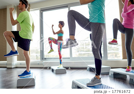group of people raising legs on step platforms 17761672