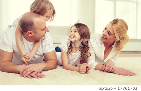 parents and two girls lying on floor at home 17761703