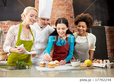 happy women and chef cook baking in kitchen 17762248