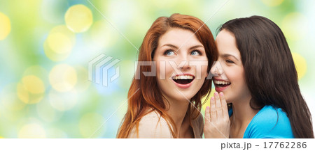 teenage girls or women whispering gossip 17762286