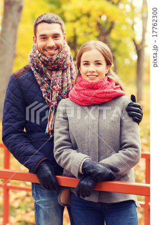 smiling couple hugging on bridge in autumn park 17762300