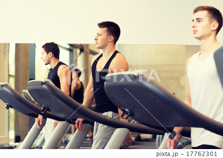 group of men exercising on treadmill in gym 17762301