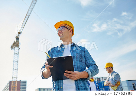 builder in hardhat with clipboard at construction 17762399
