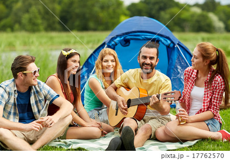 happy friends with drinks and guitar at camping happy friends with drinks and guitar at camping 17762570