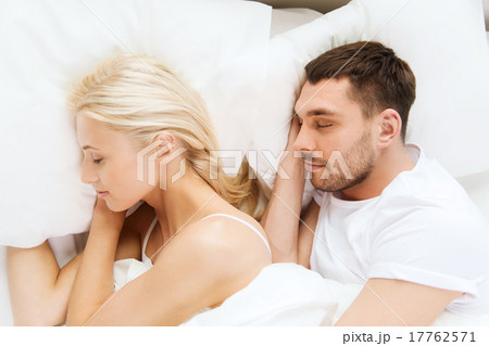 happy couple sleeping in bed 17762571