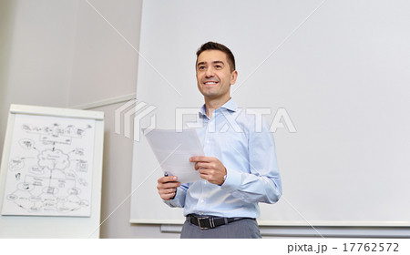 smiling businessman on presentation in office smiling businessman on presentation in office 17762572