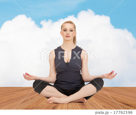 happy young woman meditating in yoga lotus pose 17762596
