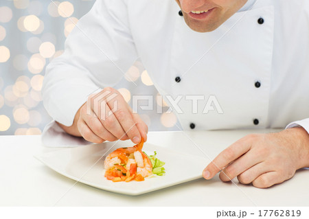close up of happy male chef cook decorating dish 17762819