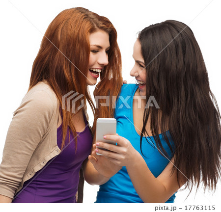 two smiling teenagers with smartphone 17763115